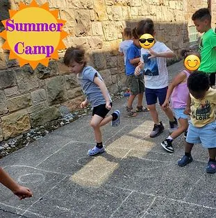 Children playing an outdoor chalk game together during summer camp